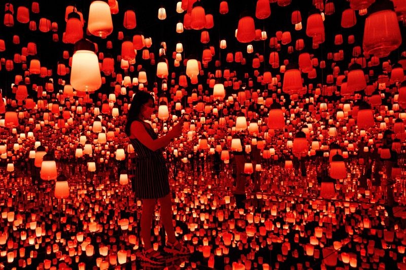 Japan’s premier digital art collective, TeamLab, has created beautiful art installations in Tokyo and elsewhere in Japan that test the boundaries of interactive art, featuring themes such as water, light, and traditional Japanese motifs. Above, Forest of Lamps" digital installation room with hanging lamps which illuminate as visitors near them. Image Credit: AFP